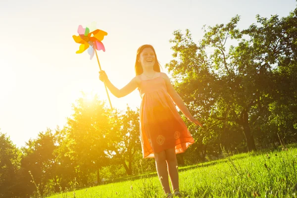 Menina feliz com brinquedo pinwheel — Fotografia de Stock
