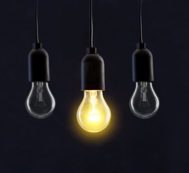 Light bulb lamps on black background clipart