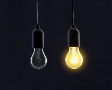 Light bulb lamps on black background clipart