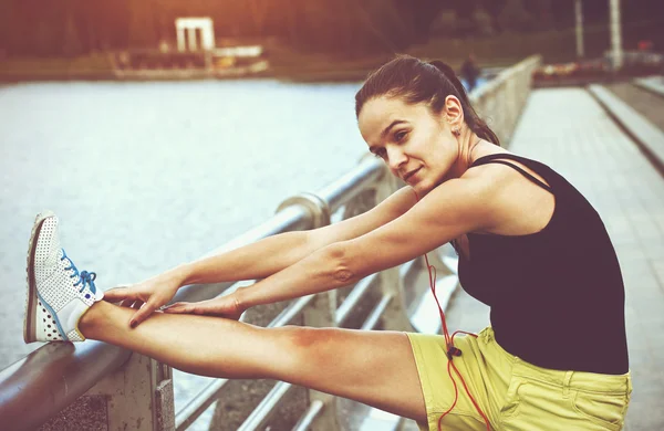 Menina esportiva fazendo aquecimento alongamento pernas antes de correr — Fotografia de Stock