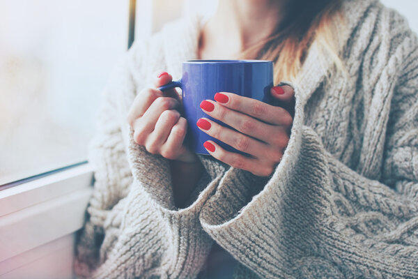 hands holding hot cup of coffee