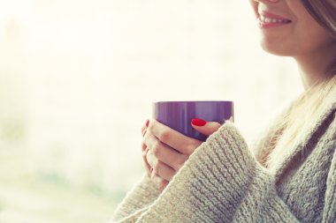 Ellerin kahve bardağını tutuyor.