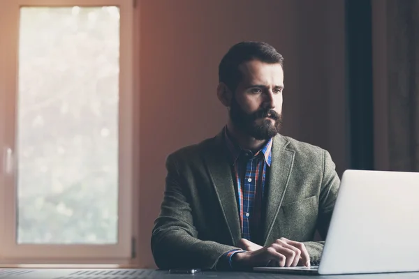 Businessman sitting with laptop — Stock Photo, Image