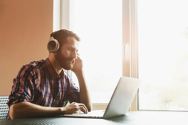 Hombre en auriculares con portátil —  Fotos de Stock