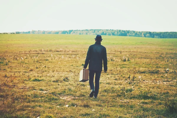 man going with suitcase