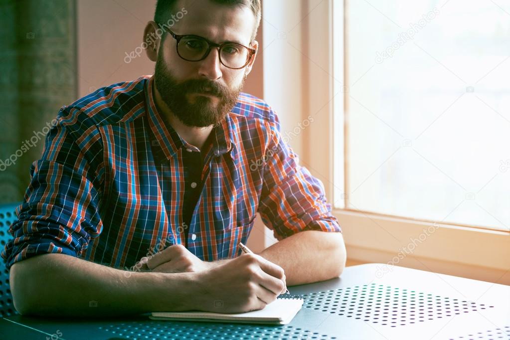 man with pen and notebook