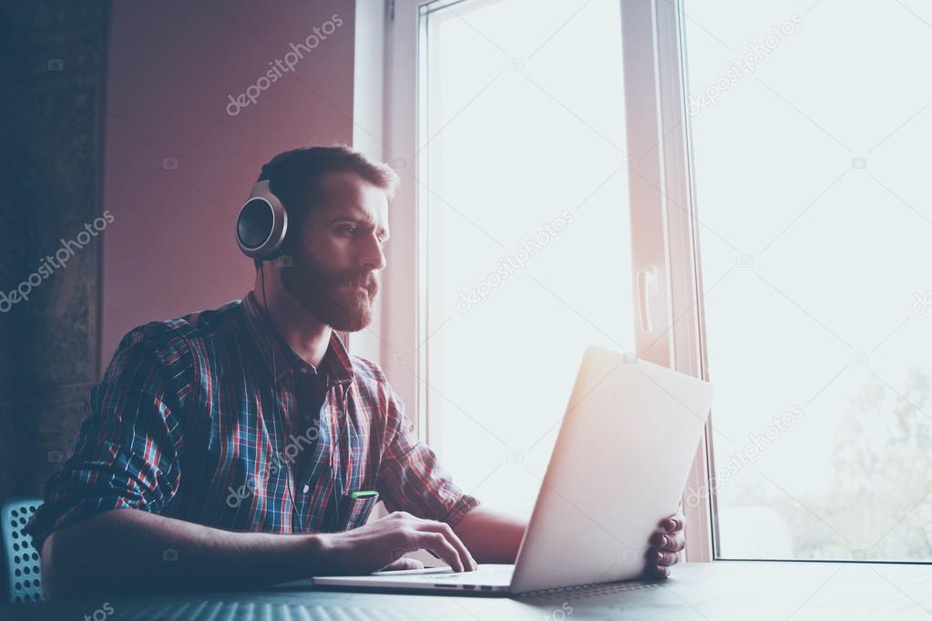 bearded man  in headphones