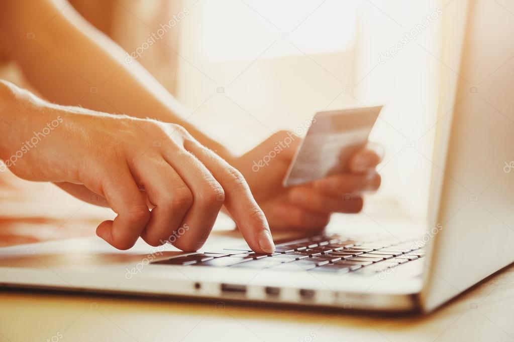 Hands holding credit card