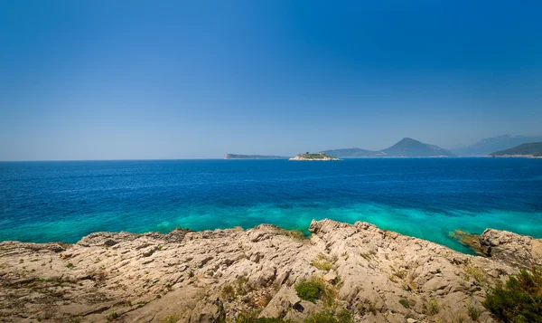 Adriatic sea rocky coast and old fortress ruins on a small island — Stock Photo, Image