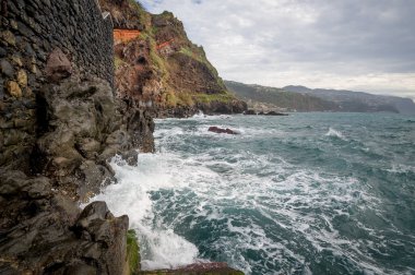 Madeira adasının okyanus dalgaları ve dik kayaları.