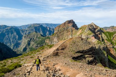 Tourist woman walking on the mountains of Madeira island clipart
