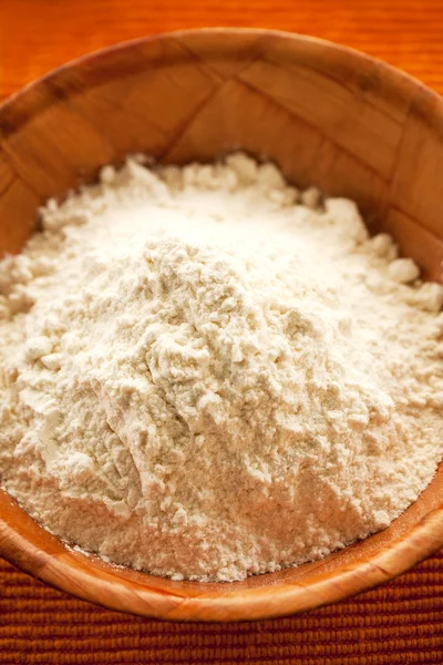 Wheat flour in wooden bowl — Stock Photo, Image