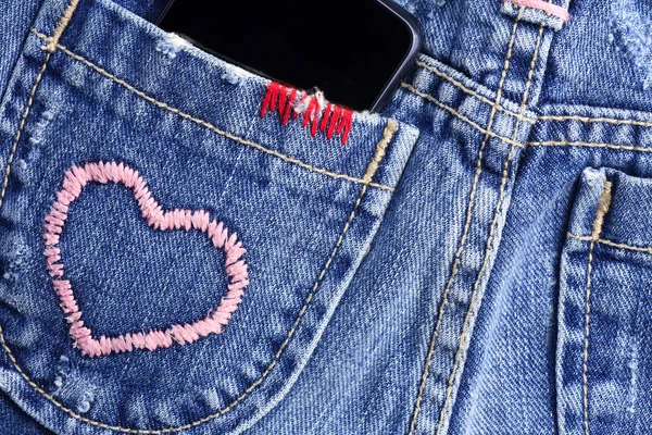 Smart phone in the pocket of jeans — Stock Photo, Image