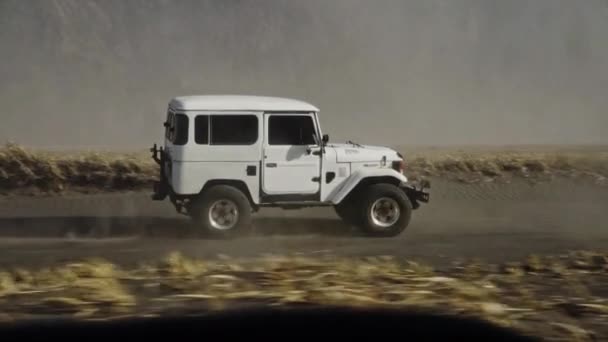 Jeep dirigindo através da trilha da sujeira do deserto — Vídeo de Stock