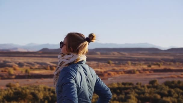 Tourist in der Wüste und mit Blick auf Ait Benhaddou — Stockvideo