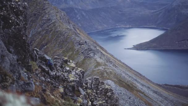 Randonneur sur une colline escarpée au-dessus du fjord — Video