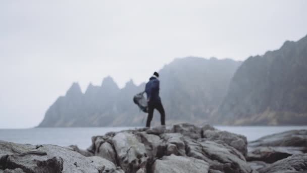 Hiker Removing Backpack On Fjord Rocks — Stock Video