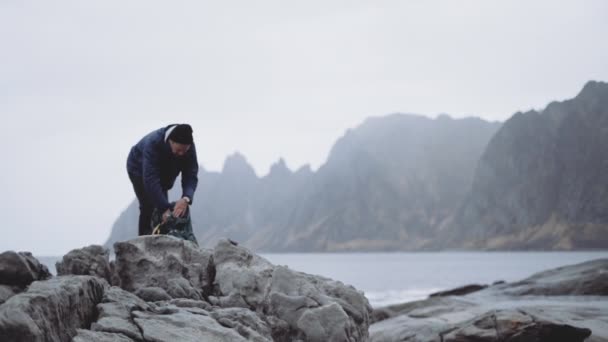 Hiker Reaching For Camera By Fjord Rocks — Stock Video