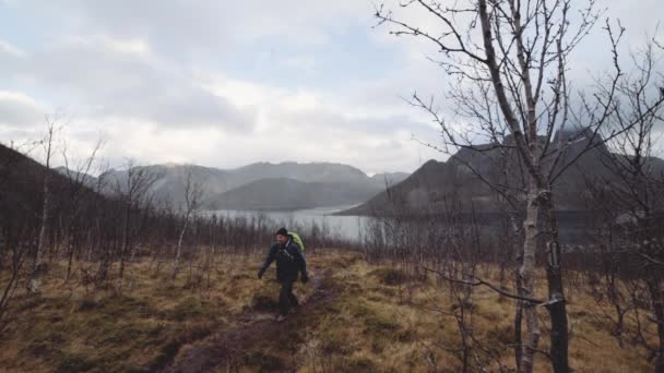 Man Hiking Over Wet Grassland — Stock Video