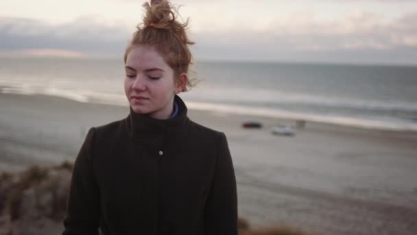 Pelirroja adolescente tomando selfie en viento playa — Vídeo de stock