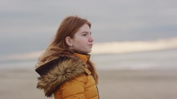 Röd tonåring i orange rock vid stranden — Stockvideo