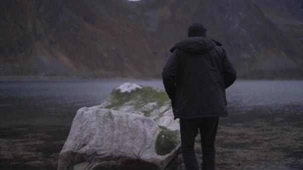 Man Stepping Over Stones To Stand On Fjord Rock — Stock Video