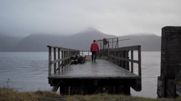 Hiker On Old Pier In Fjord — Stock Video
