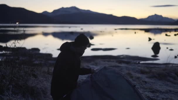 Man Arranging Tent On Frozen Ground — Stock Video