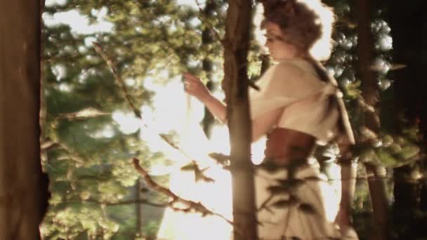 Woman In Headdress Dancing In Sunlit Forest — Stock Video