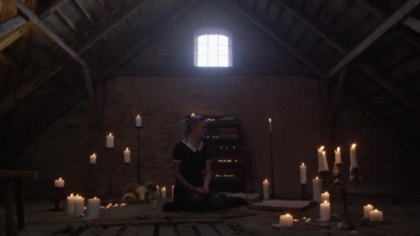 Young, Tattooed Woman Kneeling In Candle Lit Attic — Stock Video