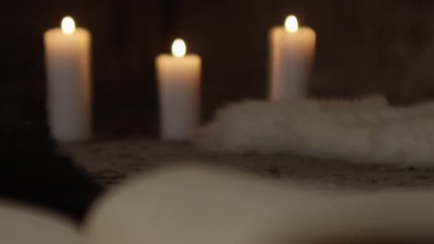 Candles And Pages Of Music In Opened Book — Stock Video