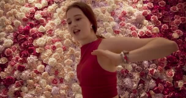 Woman with Pouty Lips Dancing in Front of Paper Flowers — Wideo stockowe