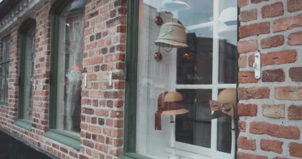 Woman Looking At Window Of Hat Shop In Old Town — Stock Video