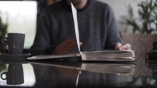Man Turning Pages Of Photograph Album — Stock video