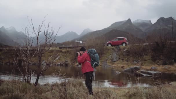 Hiker In Red With Rucksack Taking Photograph — Stock Video