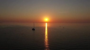 Aerial Shot of Beautiful Ocean Waters and Sunset Reflect on the Waters