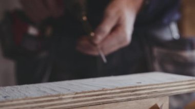 Marangoz vidaları tamir etmek için elektrikli tornavida kullanıyor