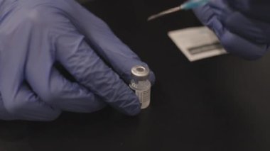 Doktor Şırıngayı Kapalı Aşı Şişesine Koyuyor
