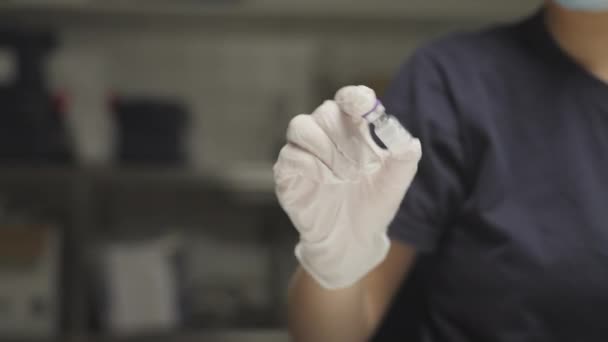 Doctor In Surgical Gloves Holding Vaccine — Stock Video