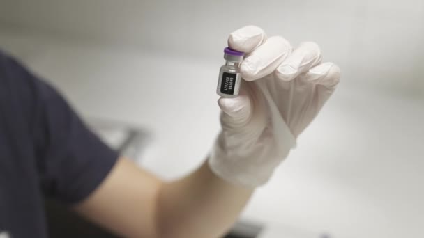 Doctor In Gloves Holding Up Covid Vaccine With Date — Stock Video