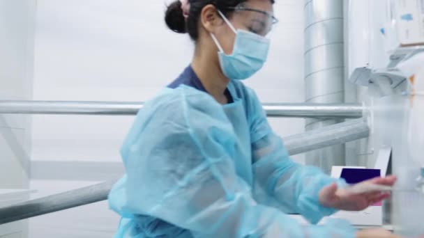 Doctor Using Phone And Cleaning Hands — Stock Video