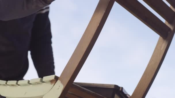 Man Painting Wooden Outdoor Chair With Paintbrush — Stockvideo