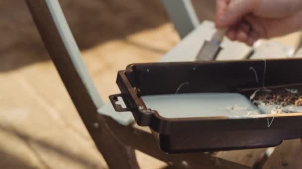 Man Painting Outdoor Chair From Tray Of Paint — Vídeo de Stock