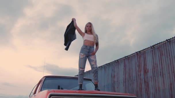 Beautiful Woman Swinging Leather Jacket On Car — Stock Video