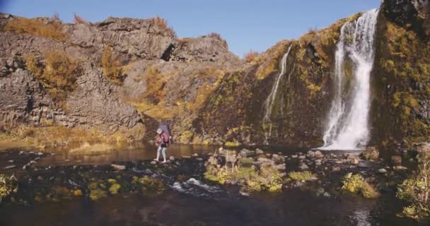 Young Hiker Stepping Over River Rocks — Stock Video