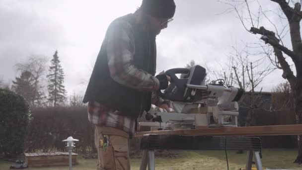 Asztalos elektromos fűrésszel favágáshoz — Stock videók