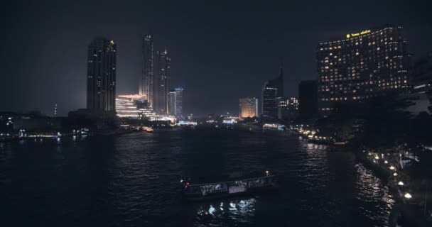 Aerial Shot of Passenger Boat Along the River at Night and City Lights — Vídeos de Stock