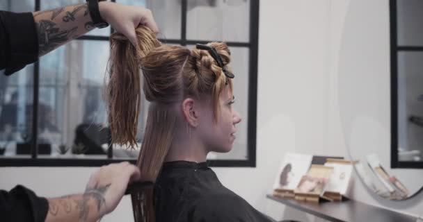 Hairdresser Combing And Bunching Woman'S Hair — Stock Video