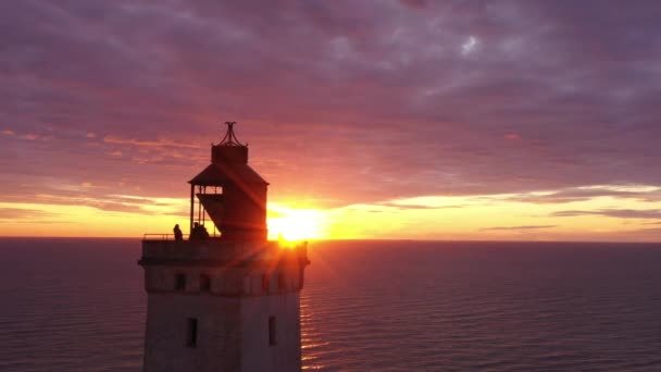 Drone Flight Over Rubjerg Knude Lighthouse Under Dramatic Sunset — Stock Video