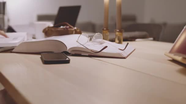 Smartphone, Open Book And Glasses On Table In University — Wideo stockowe